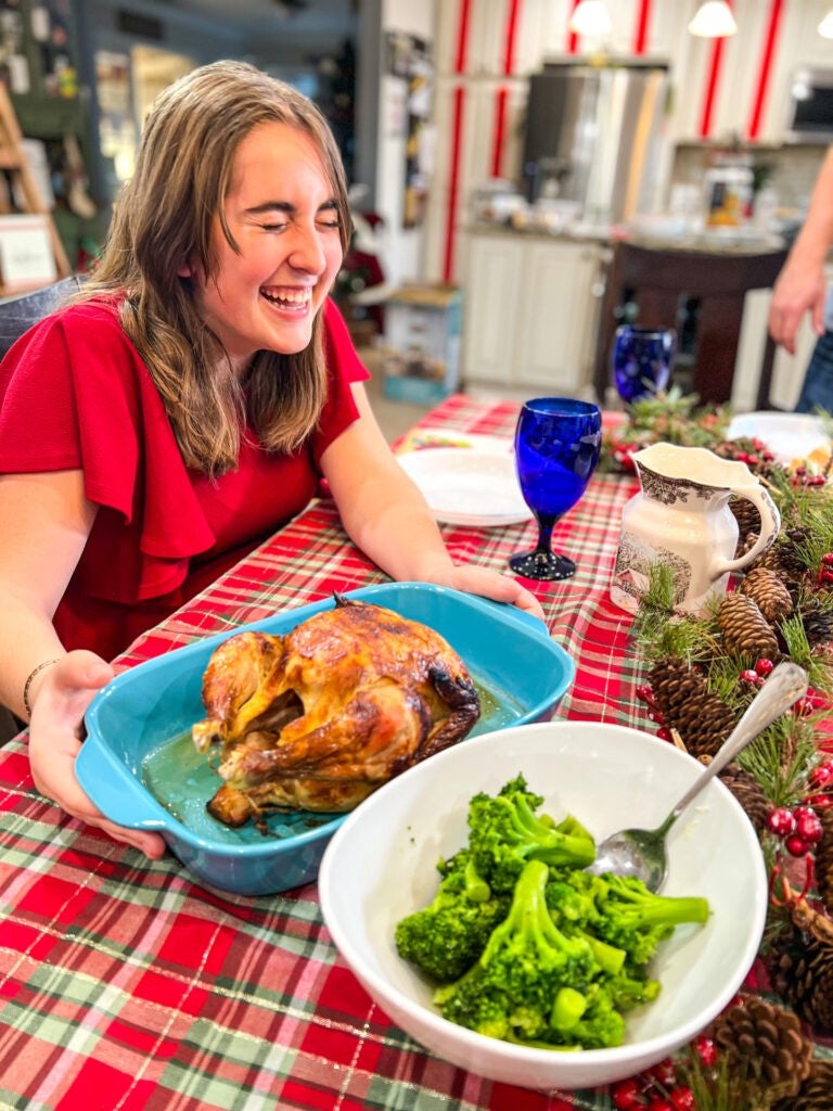 Girl with rotisserie chicken and broccoli