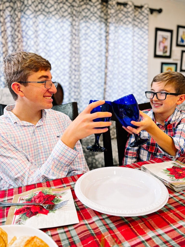 two brothers toasting with blue glasses