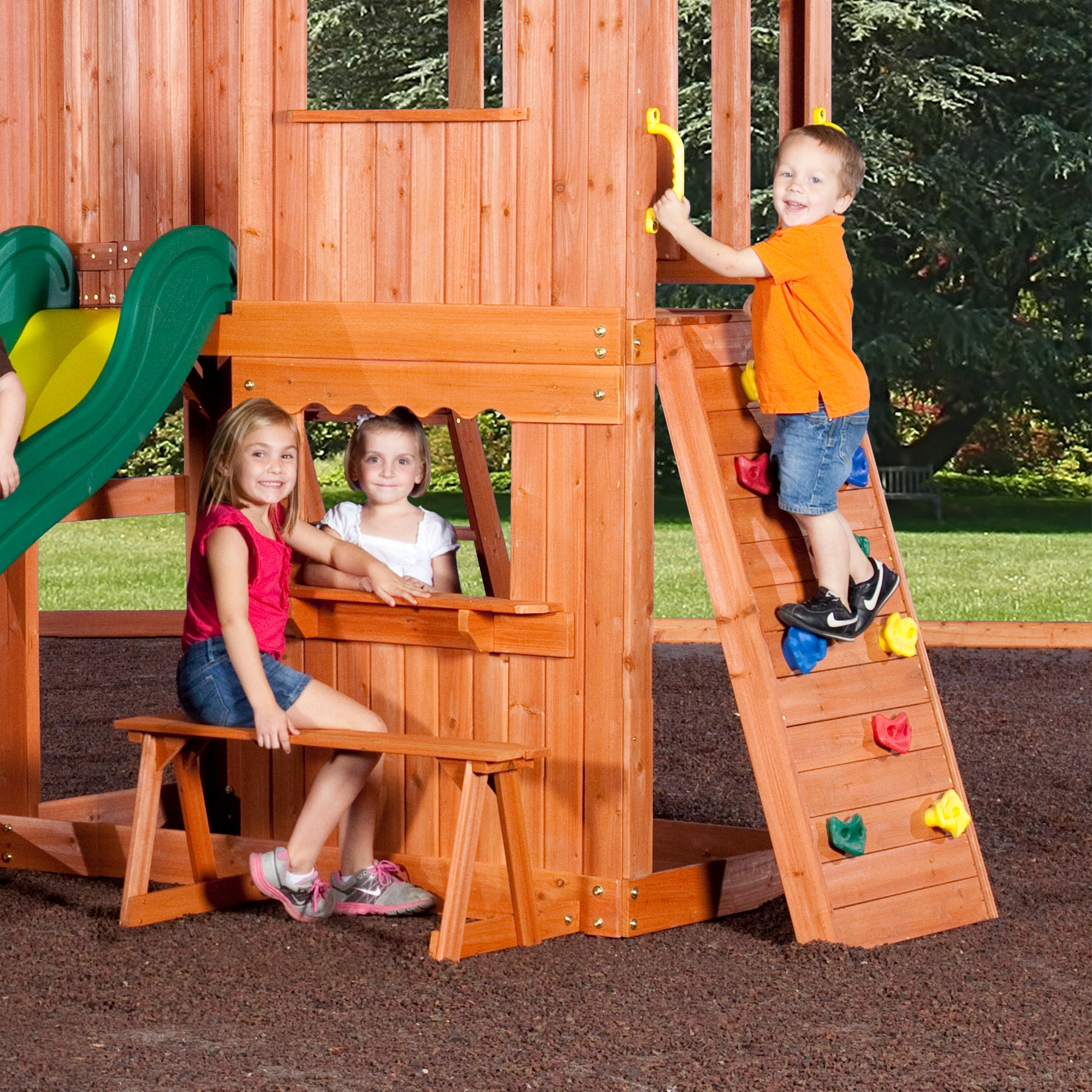 3 kids in playhouse and on climbing wall