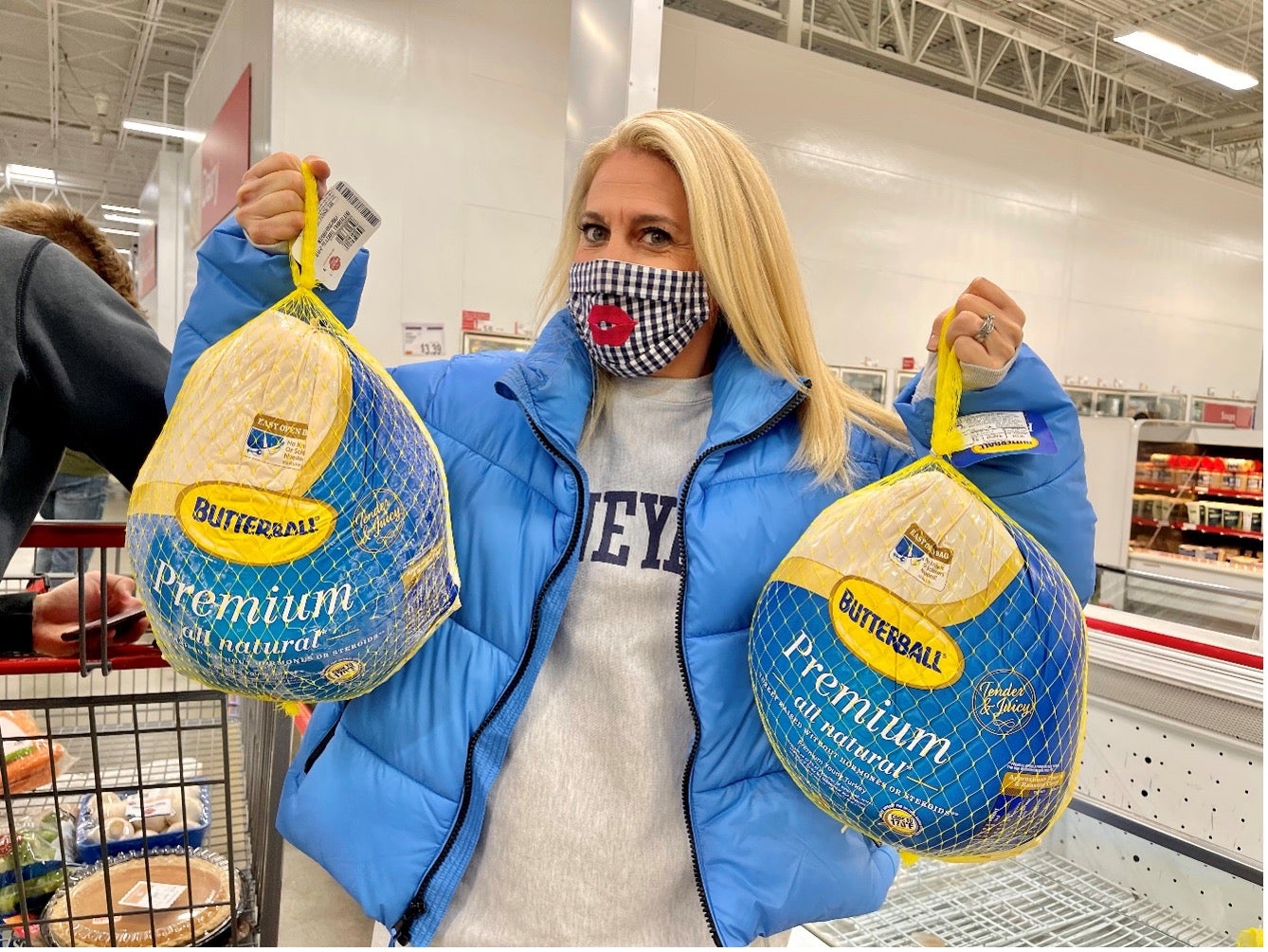 Woman holding two frozen Butterball turkeys