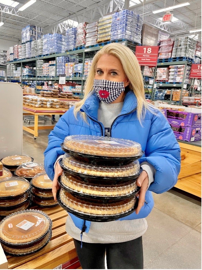 Woman holding four Wellsley Farms bakery pies
